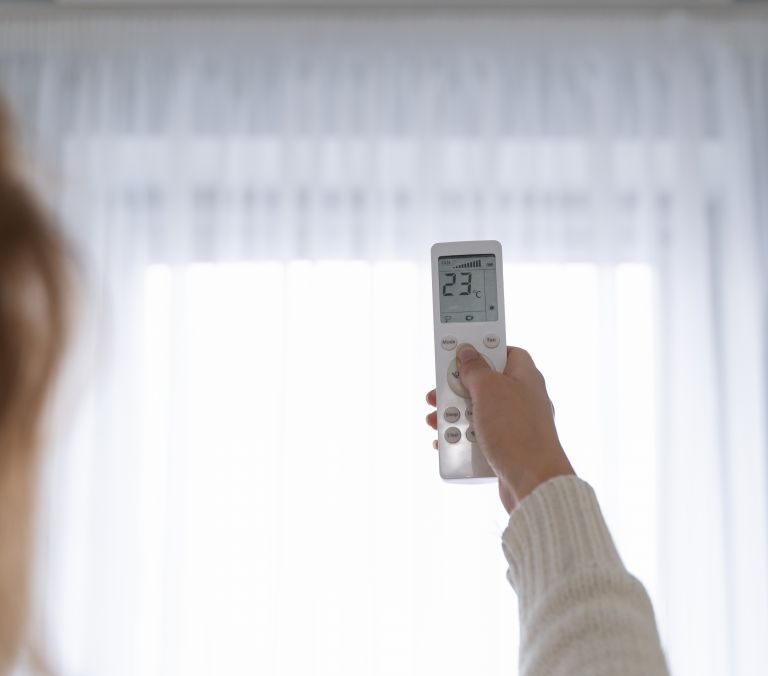 woman holding remote start heater