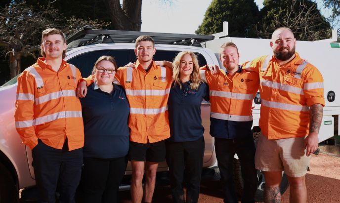 Aleck and Sarah Parry with the Level Plumbing Lithgow team, now part of Level Group ANZ