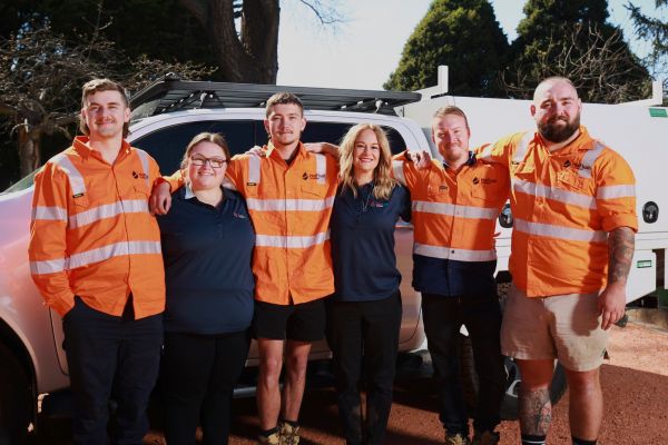 Aleck and Sarah Parry with the Level Plumbing Lithgow team, now part of Level Group ANZ