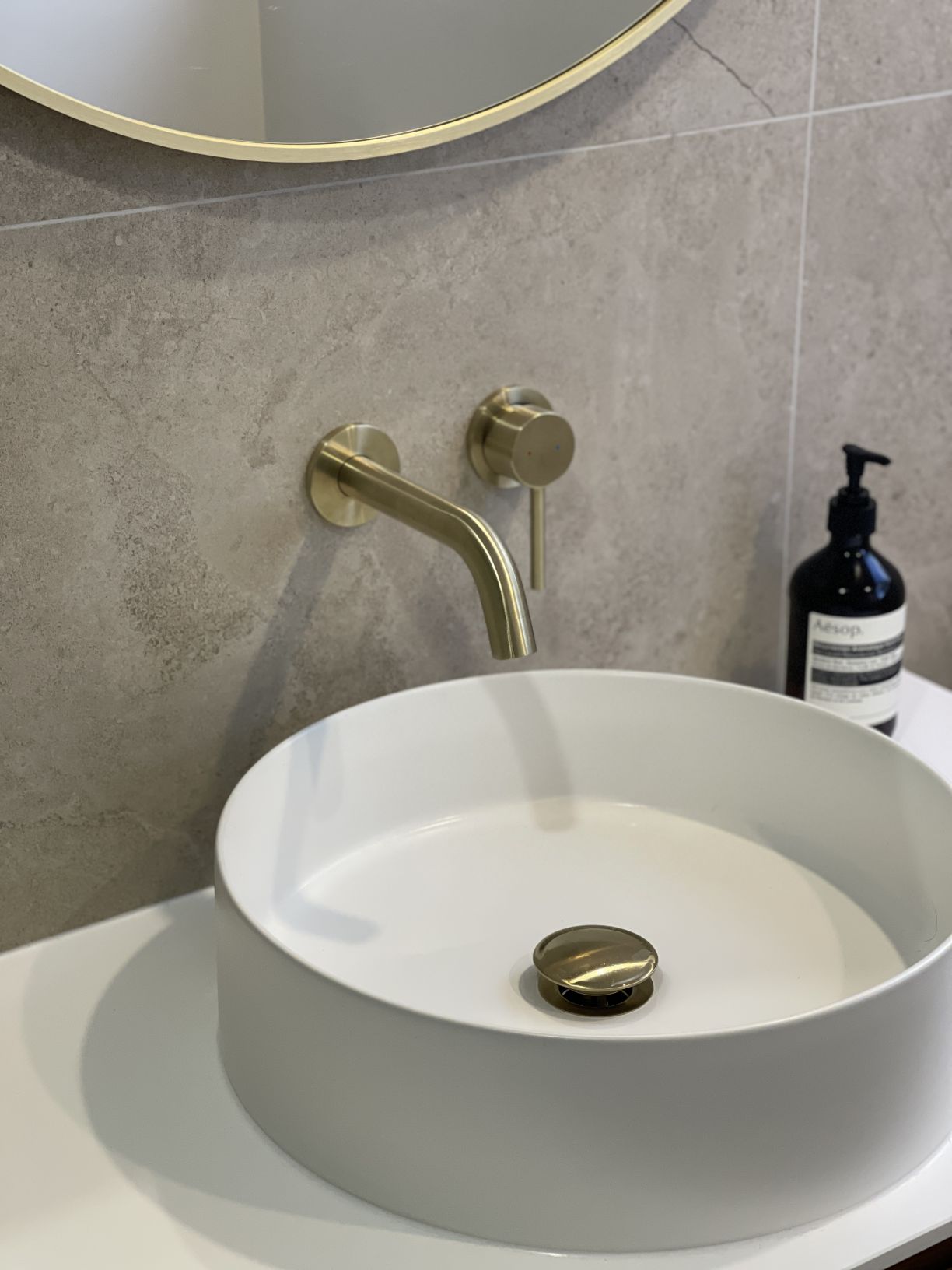 Modern bathroom renovation featuring a brushed brass tap and vessel sink completed by Level Plumbing Howick