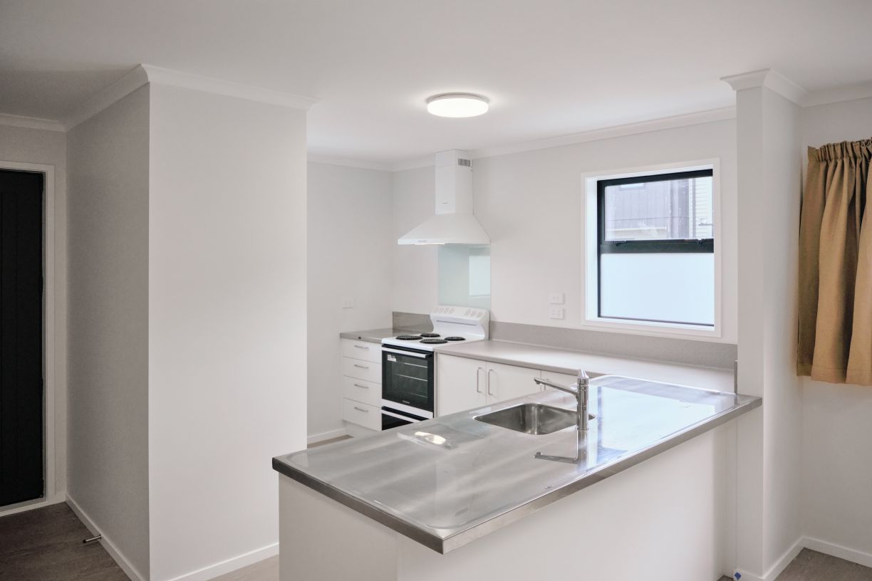 Stainless steel kitchen bench top with mixer tap installation for multi-unit housing project