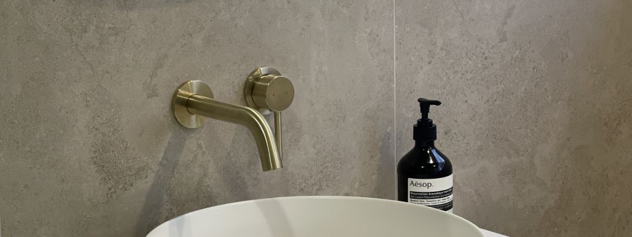 Clean modern vanity top with white vessel sink and brushed brass tapware by Level Plumbing Howick