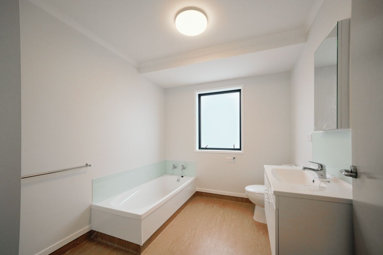 Newly installed modern bathroom fixtures and vanity fitout in a multi-unit residential unit