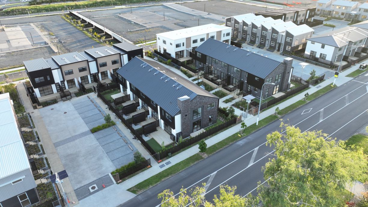 Aerial view of completed multi-unit townhouse block featuring roof stormwater drainage and plumbing infrastructure