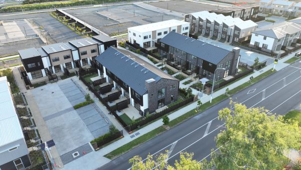 Aerial view of completed multi-unit townhouse block featuring roof stormwater drainage and plumbing infrastructure