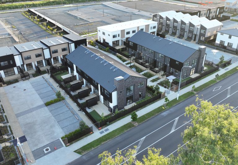 Aerial view of completed multi-unit townhouse block featuring roof stormwater drainage and plumbing infrastructure