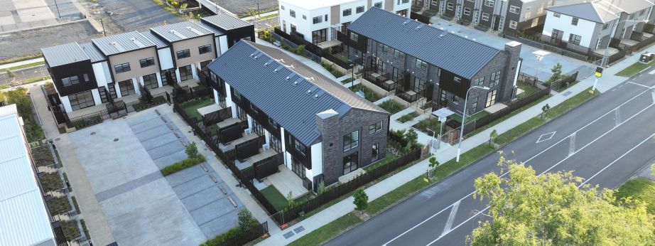 Aerial view of completed multi-unit townhouse block featuring roof stormwater drainage and plumbing infrastructure
