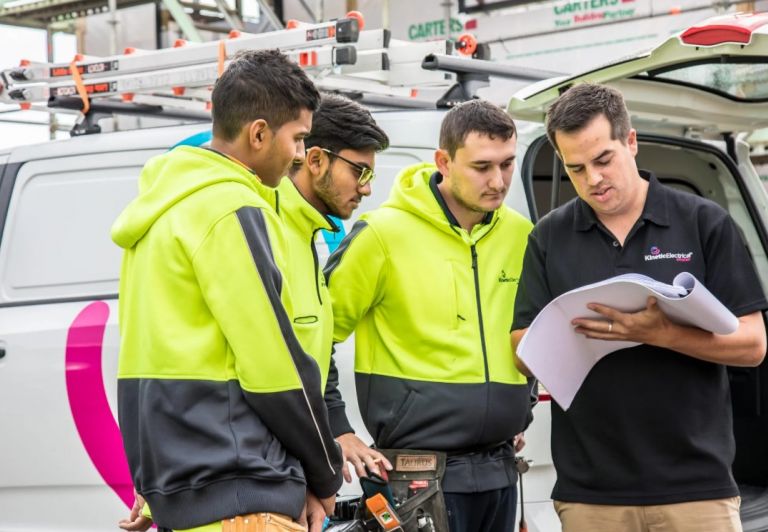 Kinetic Electrical team reviewing plans on site following announcement joining Level in New Zealand