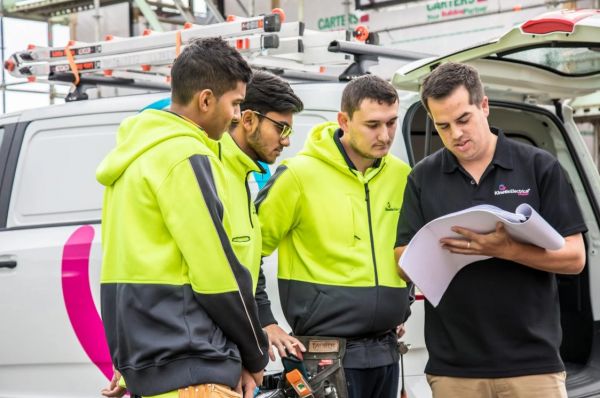 Kinetic Electrical team reviewing plans on site following announcement joining Level in New Zealand