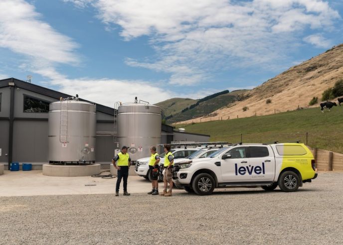 Level Electrical Ashburton team and vehicles at Wongan Hills dairy shed installation in Banks Peninsula